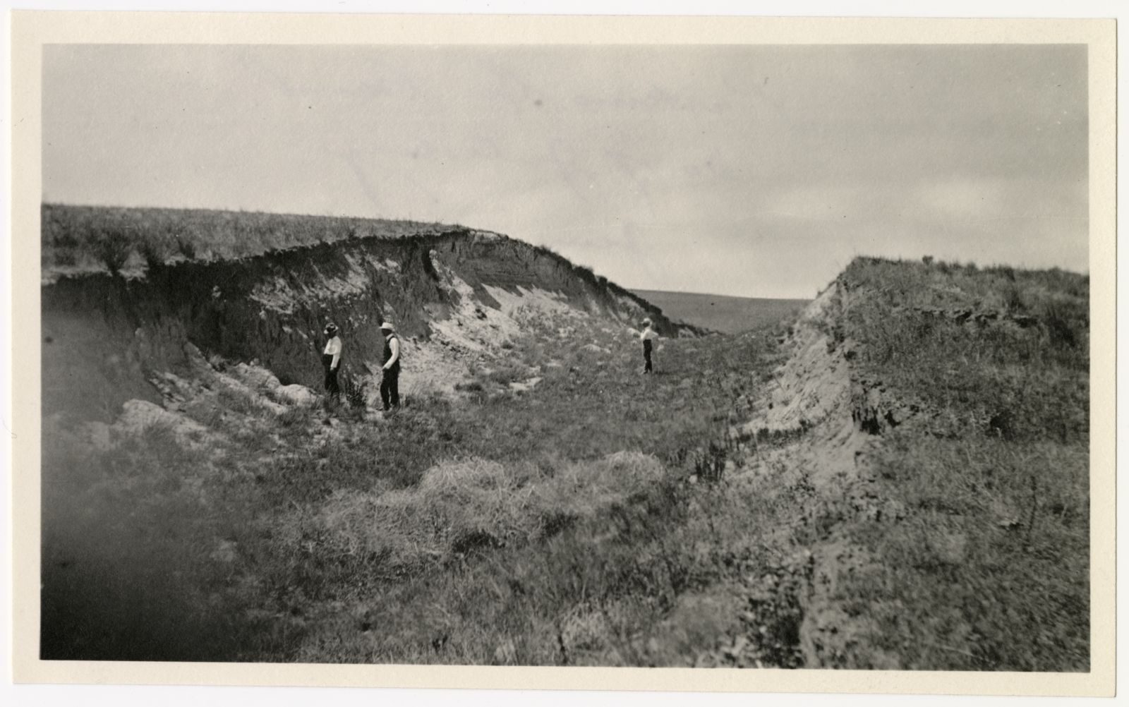 A photograph, 1918 June 24. Three men standing in Perkins County Canal.