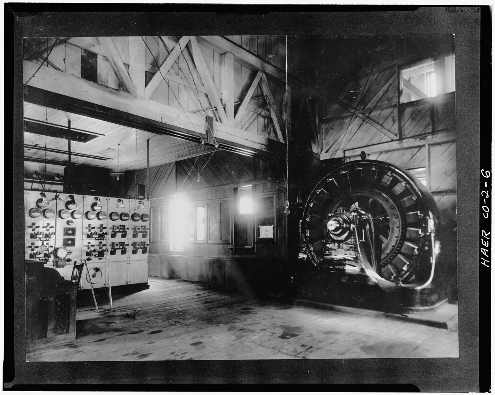 Interior view (c.1900) of 1895 power house showing switchboard on left and generator on eight.