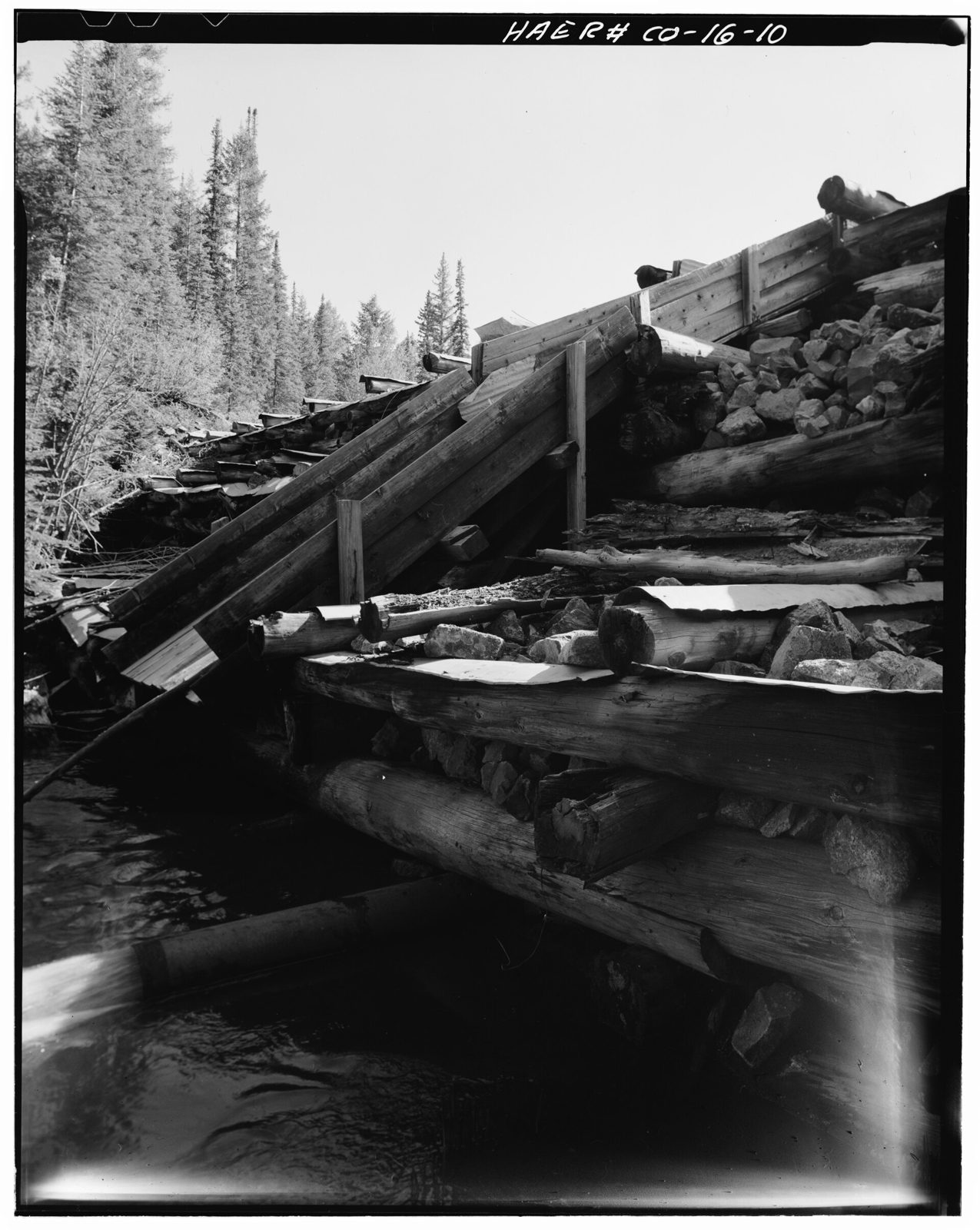 Side view- downstream face of dam with spillway and discharge pipe-1980.