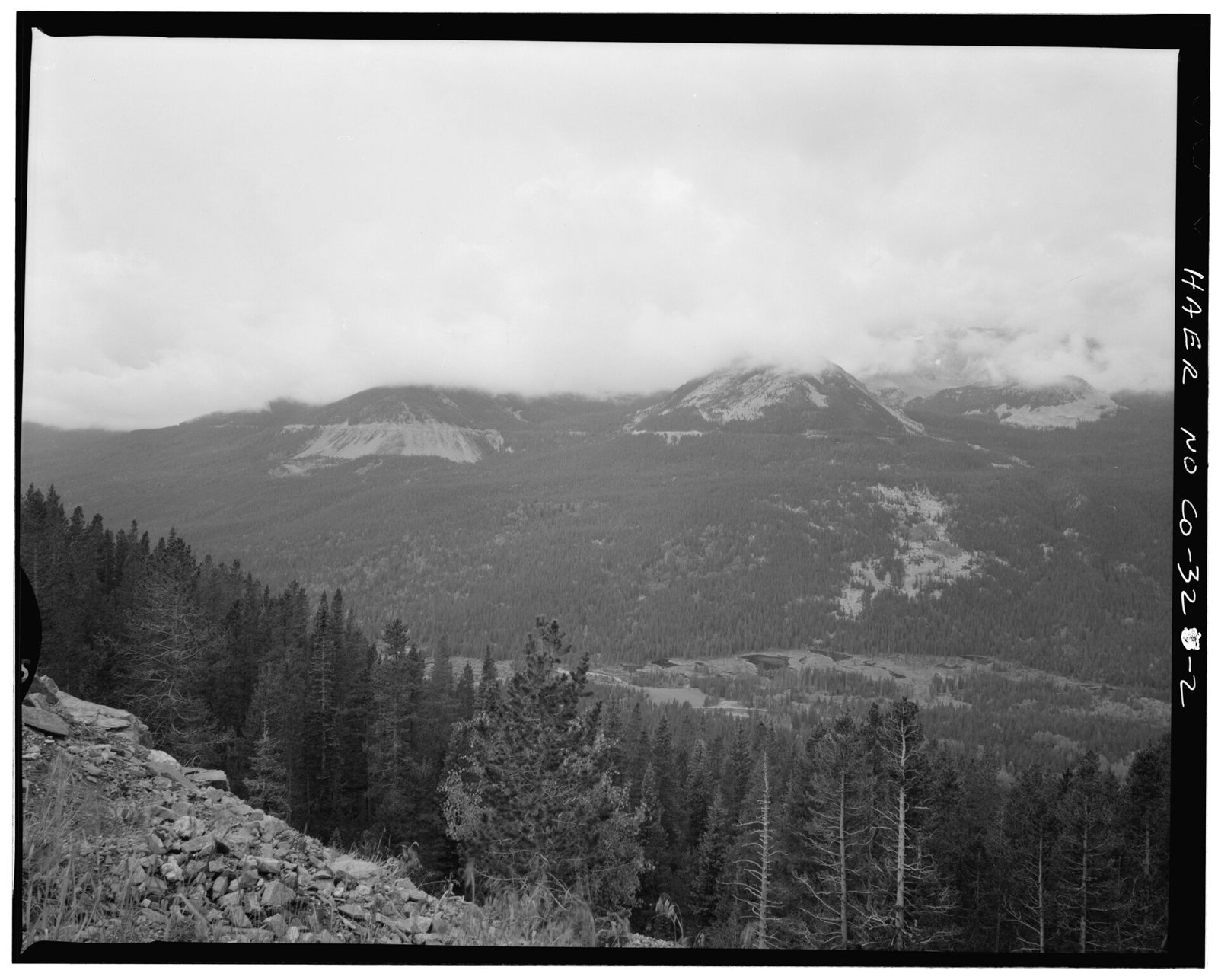 Grand Ditch view, from farview curve overlook, viewing west. Ditch is indicated by horizontal line near top of cloud covered peaks.