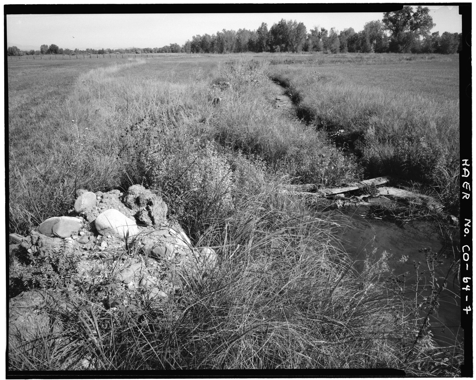 View of northerly tending lateral at easterly turn in ditch showing rock and soil removed for maintenance.