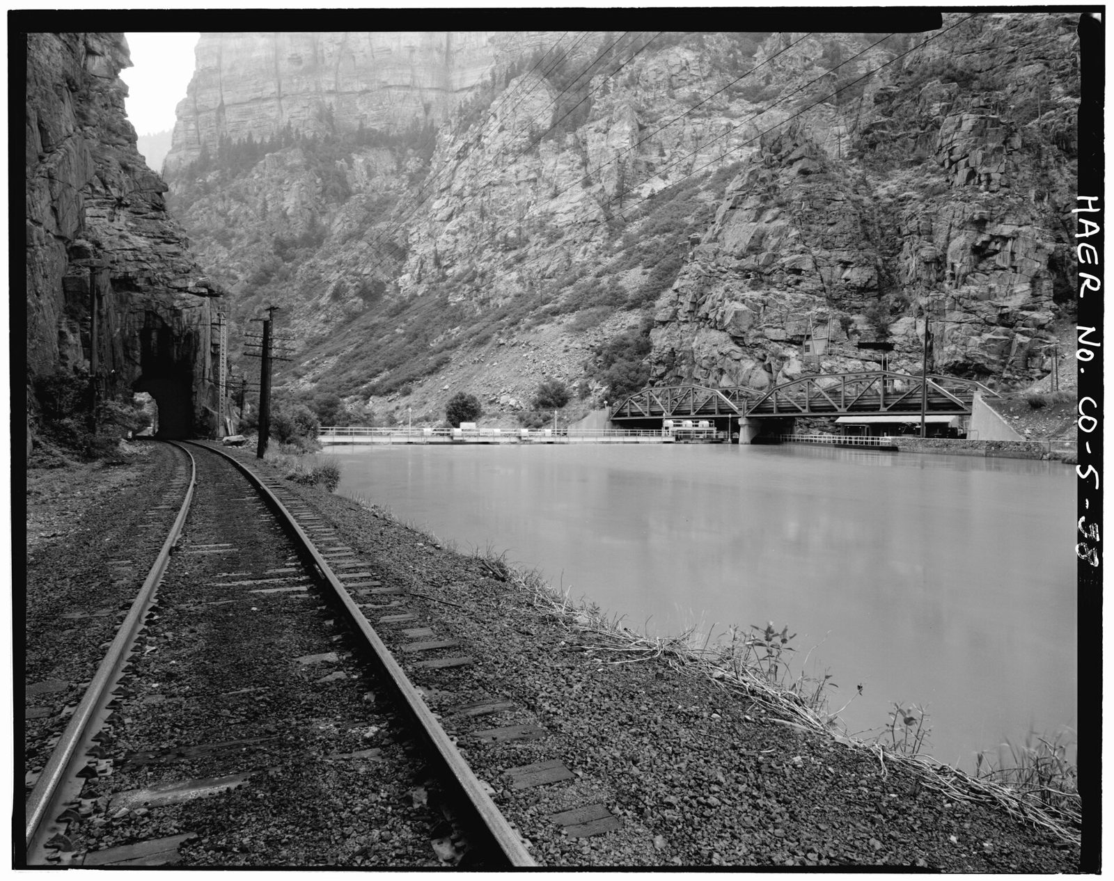 General view of Shoshone intake dam view to the west. DandRG railroad tunnel -2 and tracks to the left, U.S. Highway 6 bridges to the right.