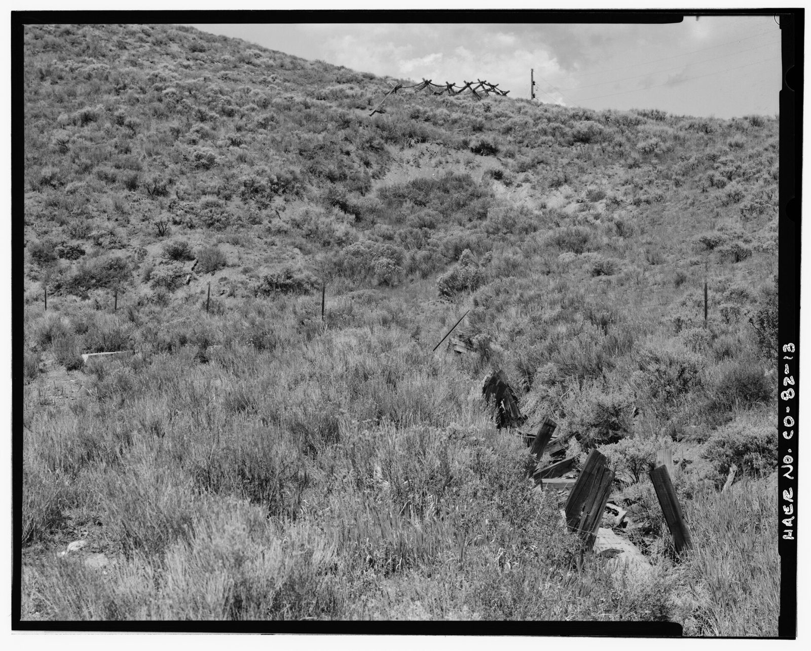 Remnants of flume box leading to slumped tunnel entrance. View is to the northwest.