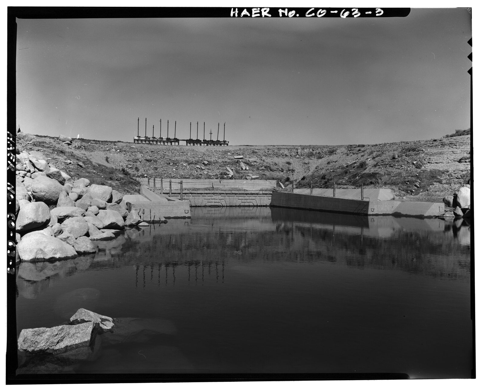 Downstream view of historic outlet works taken from the south side of the channel between the old works and twin lakes dam. View looking northwest.
