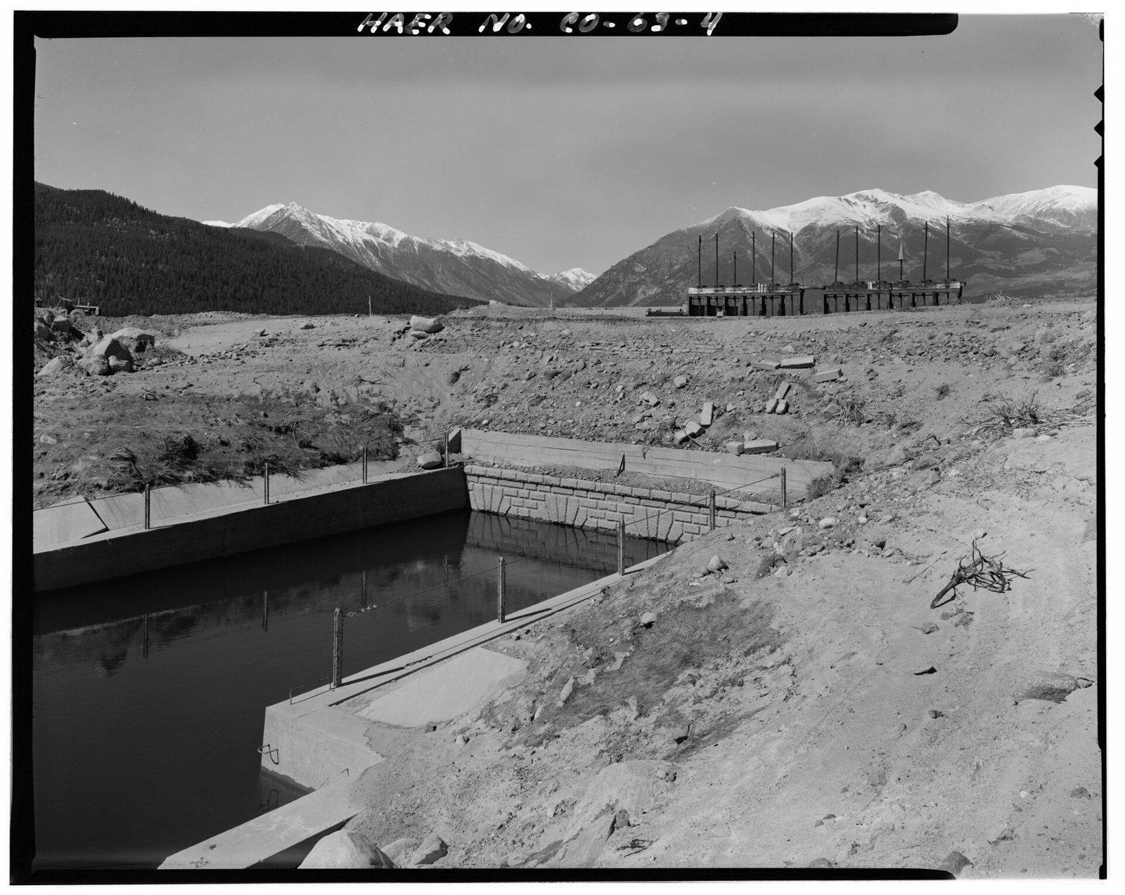 Downstream view of historic outlet works taken from the north bank of the channel between the old works and twin lakes dam. View looking west.