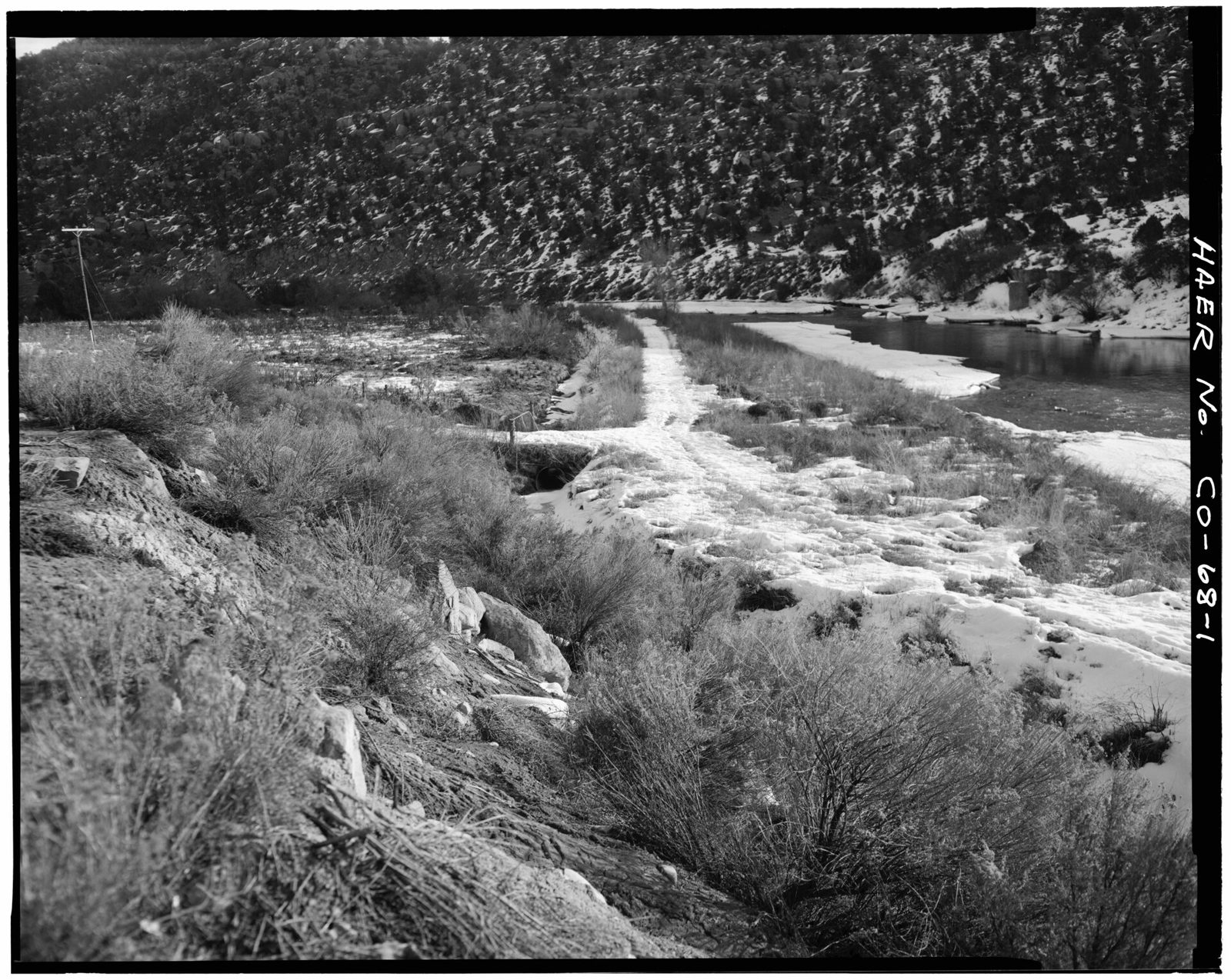 Distant view of open ditch, looking northeast. Construction project to begin immediately south of pipe culvert.